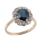 A sapphire and diamond cluster ring, the oval cut sapphire within an old cut...  A sapphire and