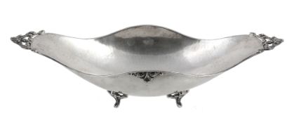An Italian hammered silver coloured elongated quatrefoil bowl, 1944-68  An Italian hammered silver