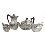 A silver three piece oblong baluster tea service by Alexander Clark & Co. Ltd  A silver three
