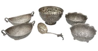 A pair of Indian silver coloured oval bowls, with loop handles  A pair of Indian silver coloured
