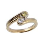 A diamond crossover ring, set with two round brilliant diamonds  A diamond crossover ring,   set