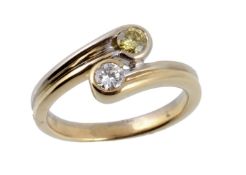 A diamond crossover ring, set with two round brilliant diamonds  A diamond crossover ring,   set