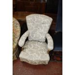 A Victorian walnut and upholstered open armchair