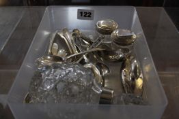 Twelve assorted silver teaspoons, a nail buffer, silver lidded pots and a mounted perfume bottle