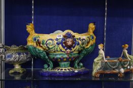 A modern Majolica centrepiece, two others and a modern Majolica vase, fan shaped with a figural
