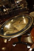A 19th century oval tray on stand with a painted scene of Pall Mall, obscurely dated 18?0. 75cm