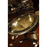 A 19th century oval tray on stand with a painted scene of Pall Mall, obscurely dated 18?0. 75cm