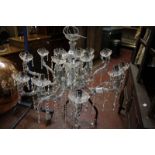A 19th century style fifteen branch glass chandelier with drop pendants, 70cm long approx. (sold