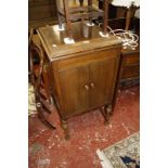 A 20th Century mahogany music cabinet Best Bid