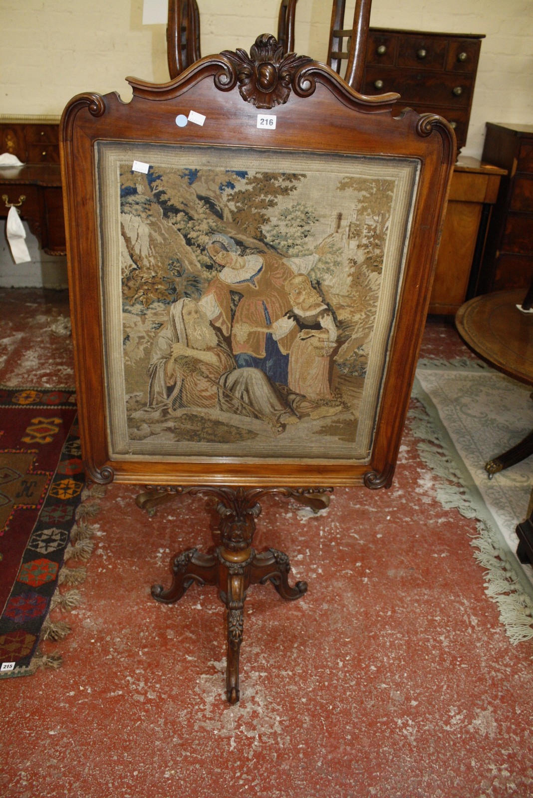 A mid 19th century mahogany firescreen with petit point panel 136cm high, 67cm wide