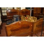 A pair of Edwardian mahogany single beds, bearing plaques 'HEAL & SON' to the headboard