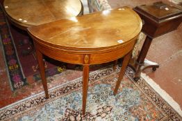 A George III mahogany and inlaid demi lune tea table on square tapering legs 89cm wide
