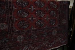 An Afghan style red ground rug 171 x 126cm