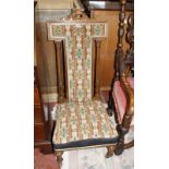 A Victorian prie dieu chair with Berlin woolwork covers, back leg stamped HOLLAND & SONS
