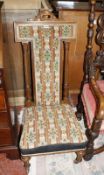 A Victorian prie dieu chair with Berlin woolwork covers, back leg stamped HOLLAND & SONS