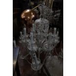 A 20th Century cut glass twelve branch chandelier with swags and drop pendants 90cm diameter (sold