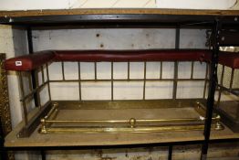 A brass club fender with red seat ( not adjustable internal measurements 122cm x 46cm) and a pair of