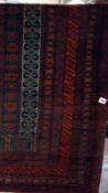 A Beluchi prayer rug in red, black and white- 61x 109 cms Best Bid