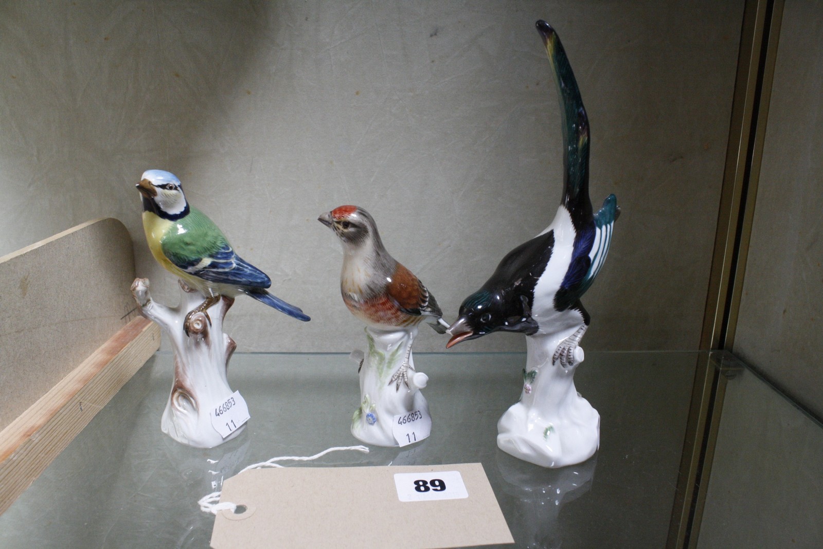 Three Meissen models of birds, comprising a blue tit, 13.5cm high, a magpie, 20cm high and another