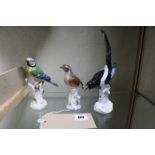 Three Meissen models of birds, comprising a blue tit, 13.5cm high, a magpie, 20cm high and another