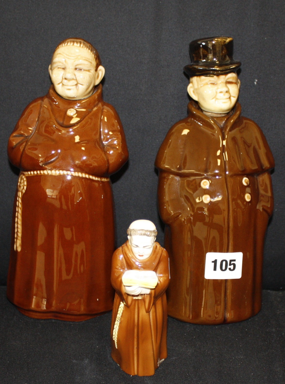 A Royal Worcester monk candlesnuffer, 12cm high, and two ceramic decanters, a coachman marked 8301