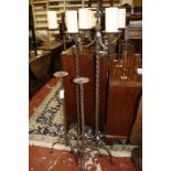 A pair of tall metal candlebra each with four pricket candle holders-152 cms and a pair of single