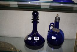 A English blue decanter, with plated Rum label and a English blue claret jug having plated neck