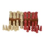 An ivory chess set, in natural and stained red, with turned pieces, thirty-two pieces, some (AF)