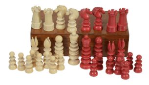 An ivory chess set, in natural and stained red, with turned pieces, thirty-two pieces, some (AF)