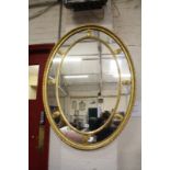 A Georgian style marginal oval gilt mirror with inner ring of patera.111cm x 81cm.