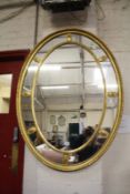 A Georgian style marginal oval gilt mirror with inner ring of patera.111cm x 81cm.