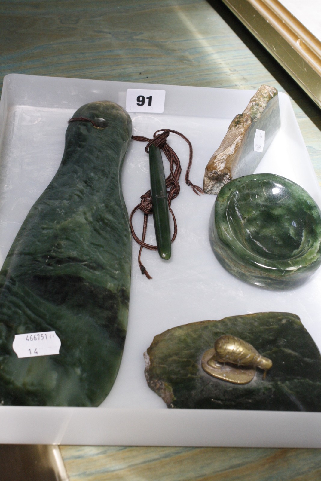 A Maori green hardstone Patu, 30cm long, a green hardstone ashtray and other green hardstone