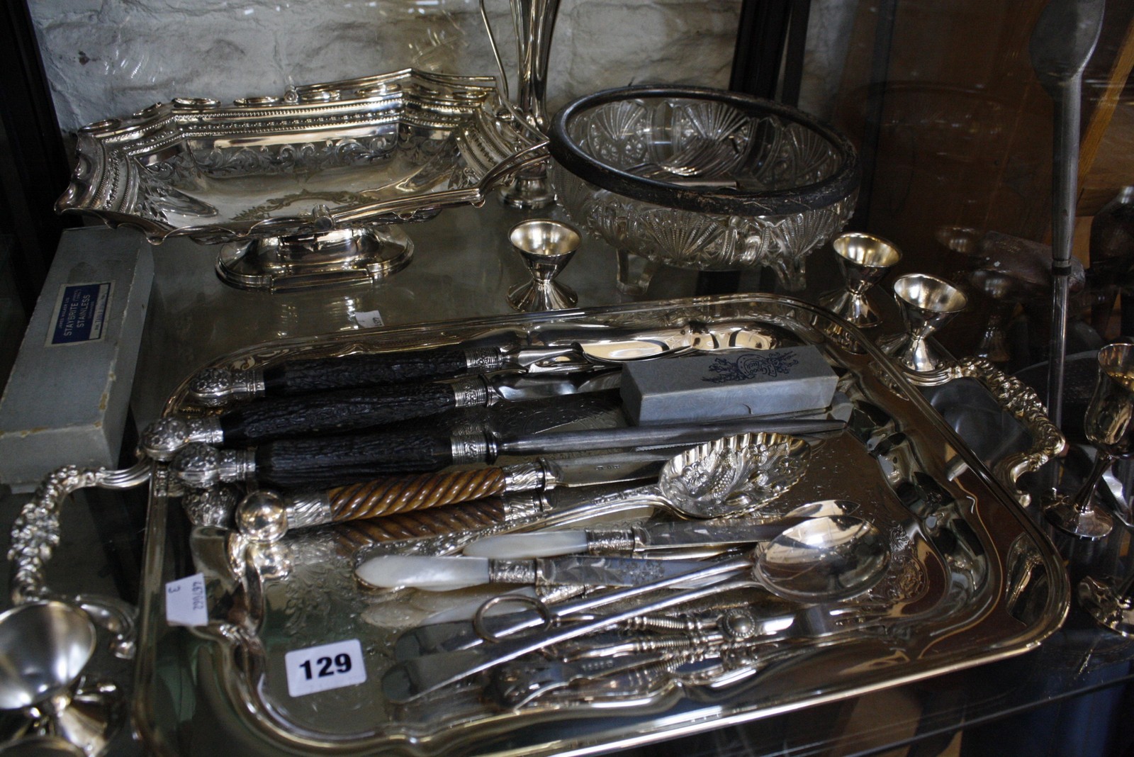 A quantity of silver and silverplate to include ten silver place card settings of street sellers/