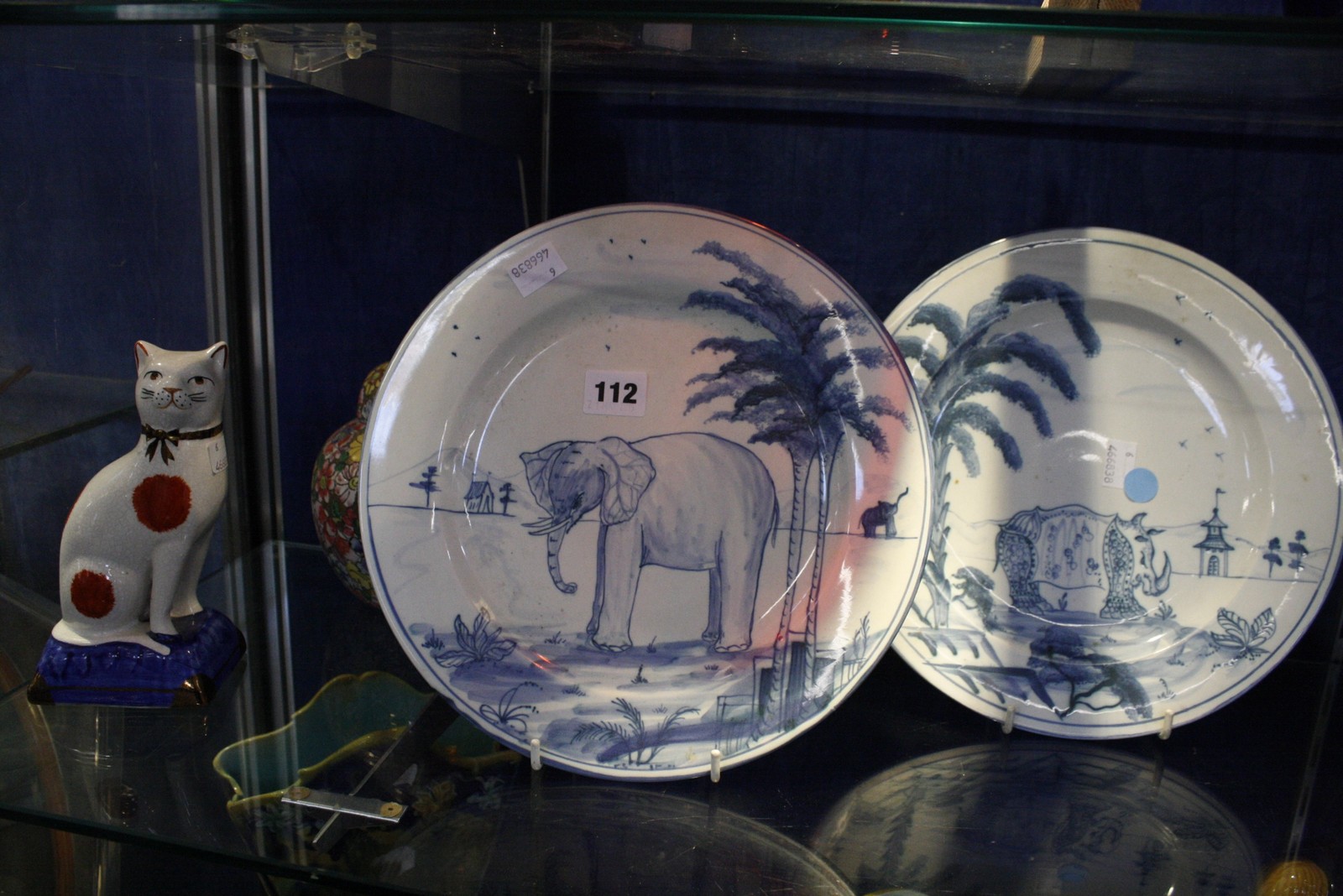 A pair of Colefax and Fowler blue and white plates, decorated with elephant and rhino, a pair of