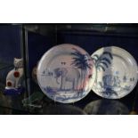 A pair of Colefax and Fowler blue and white plates, decorated with elephant and rhino, a pair of