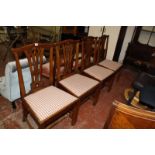 A set of four 19th Century mahogany dining chairs with pierced splats and drop in seats