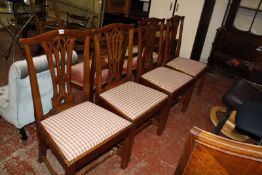 A set of four 19th Century mahogany dining chairs with pierced splats and drop in seats