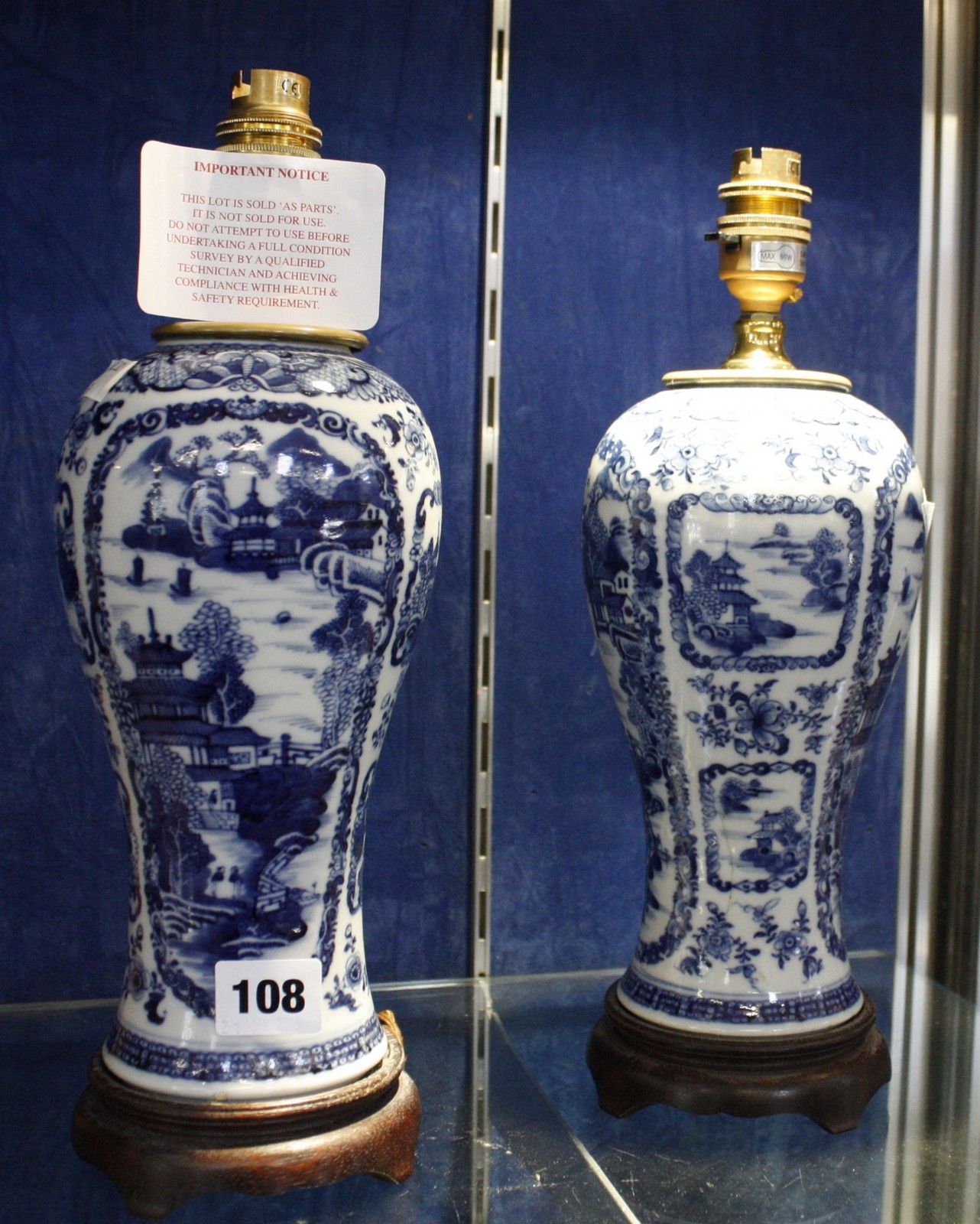 A pair of Chinese blue and white ceramic vases turned table lamps, on wooden stands, inverse