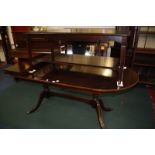 A Regency style mahogany finished dining table with two extension leaves, a matching corner
