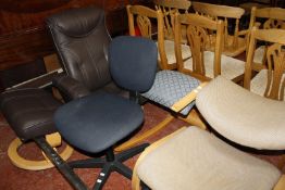 A modern leather reclining chair and stool, two orthopaedic desk chairs and a swivel office chair.