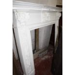 A carved wood fire surround with accompanying marble (three pieces) 135cm high 164cm wide Best Bid