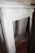 A carved wood fire surround with accompanying marble (three pieces) 135cm high 164cm wide Best Bid