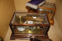 An early 20th Century oak cased barograph, 19cm high, a cased set of balance scales and an empty