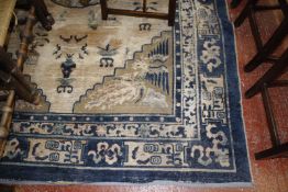 A Chinese carpet 113 x 74 inches (very worn, tears, etc.)