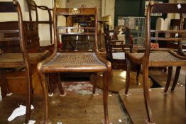 A set of four Regency simulated rosewood, brass marquetry and cane work side chairs, circa 1815
