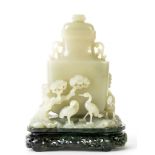 A carved white jade vase, Qing dynasty  , of flattened baluster form with well hollowed interior,