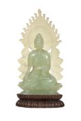 A jade figure of Buddha Shakyamuni  , seated in dhyanasana with his hands in bhumisparshamudra, on