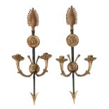 A pair of patinated and gilt metal twin light wall appliques in Empire style  A pair of patinated