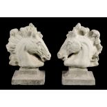 A pair of reconstituted stone pier finials modelled as horses' heads  A pair of reconstituted