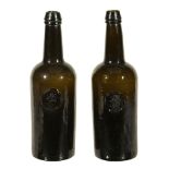 A pair of H. Ricketts & Co. Glassworks Bristol sealed wine bottles  A pair of H. Ricketts  &  Co.